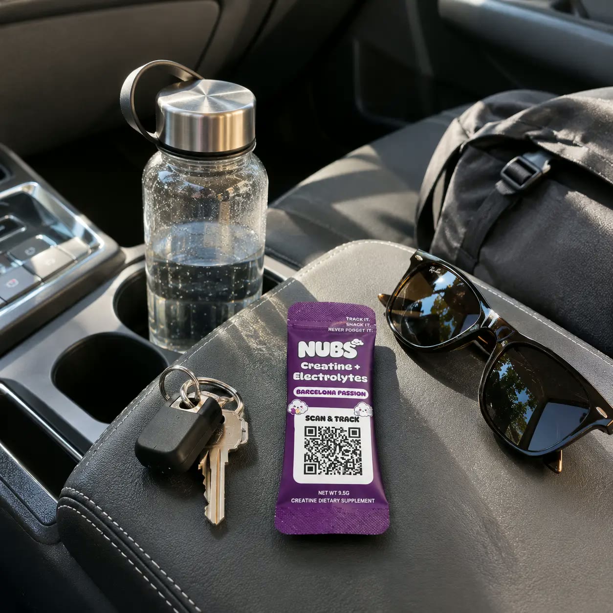 Nubs stick on a car console next to a water bottle and sunglasses