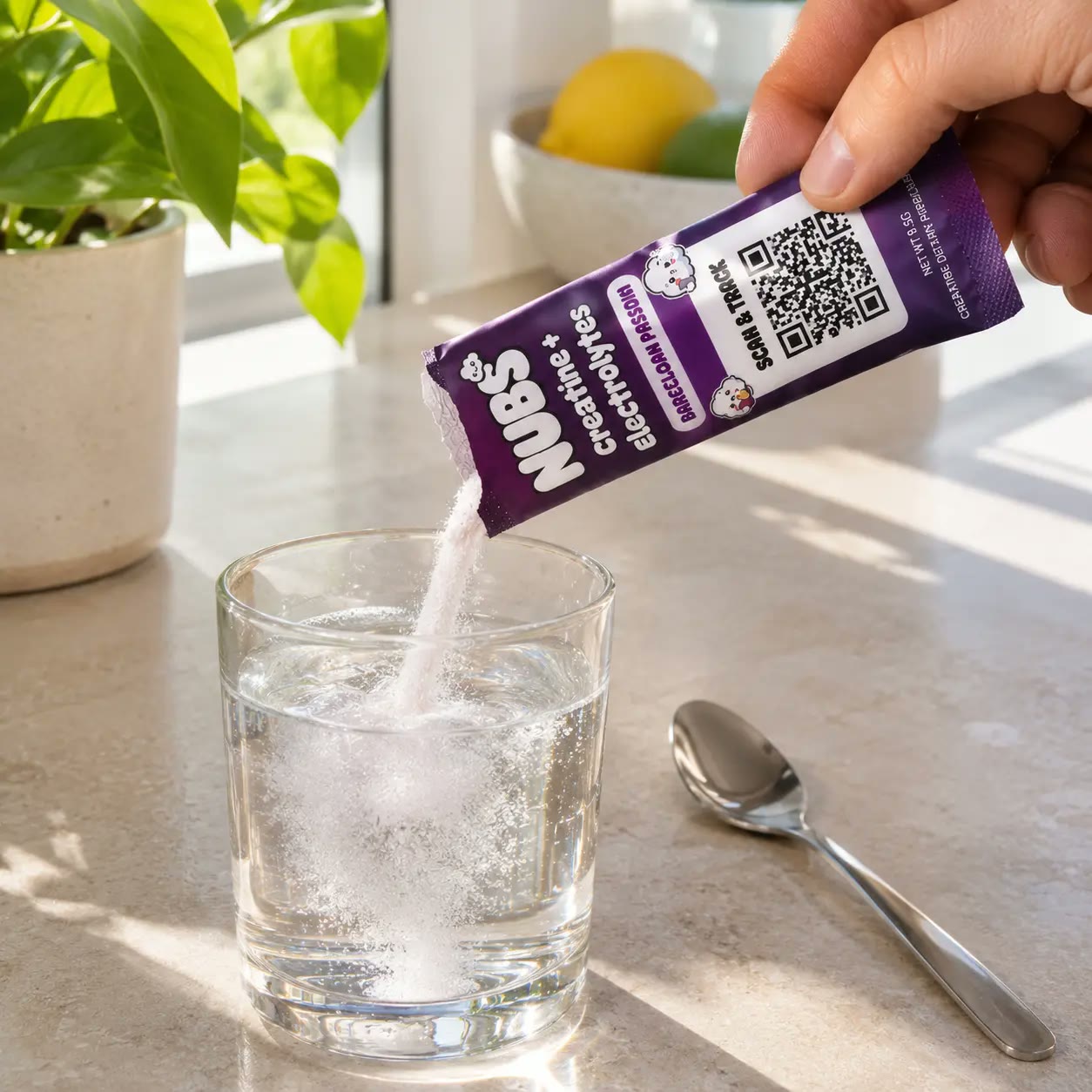 Hand pouring a Nubs stick into a glass of water on a clean counter